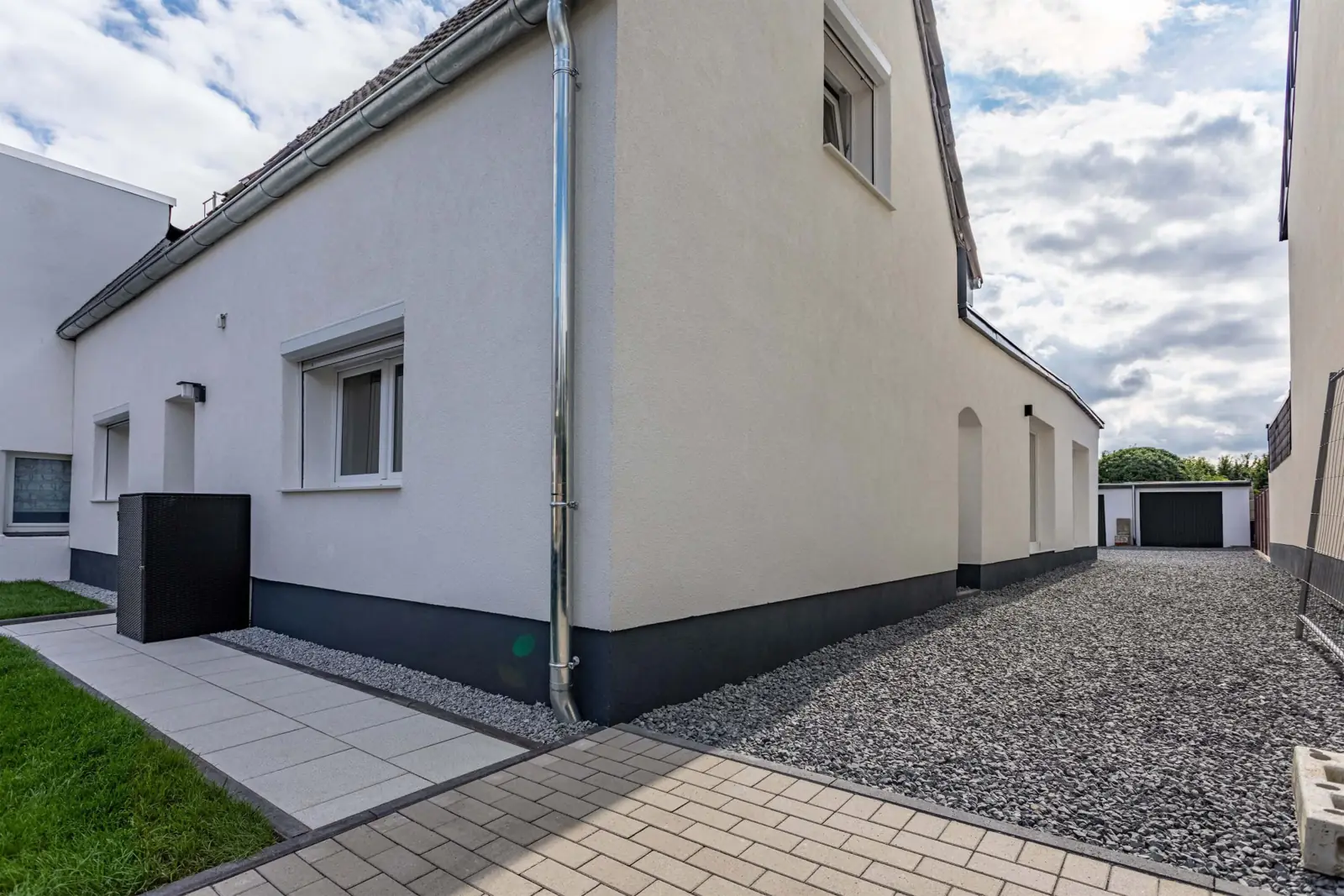 Weißes Einfamilienhaus mit dunklem Sockel in Grevenbroich